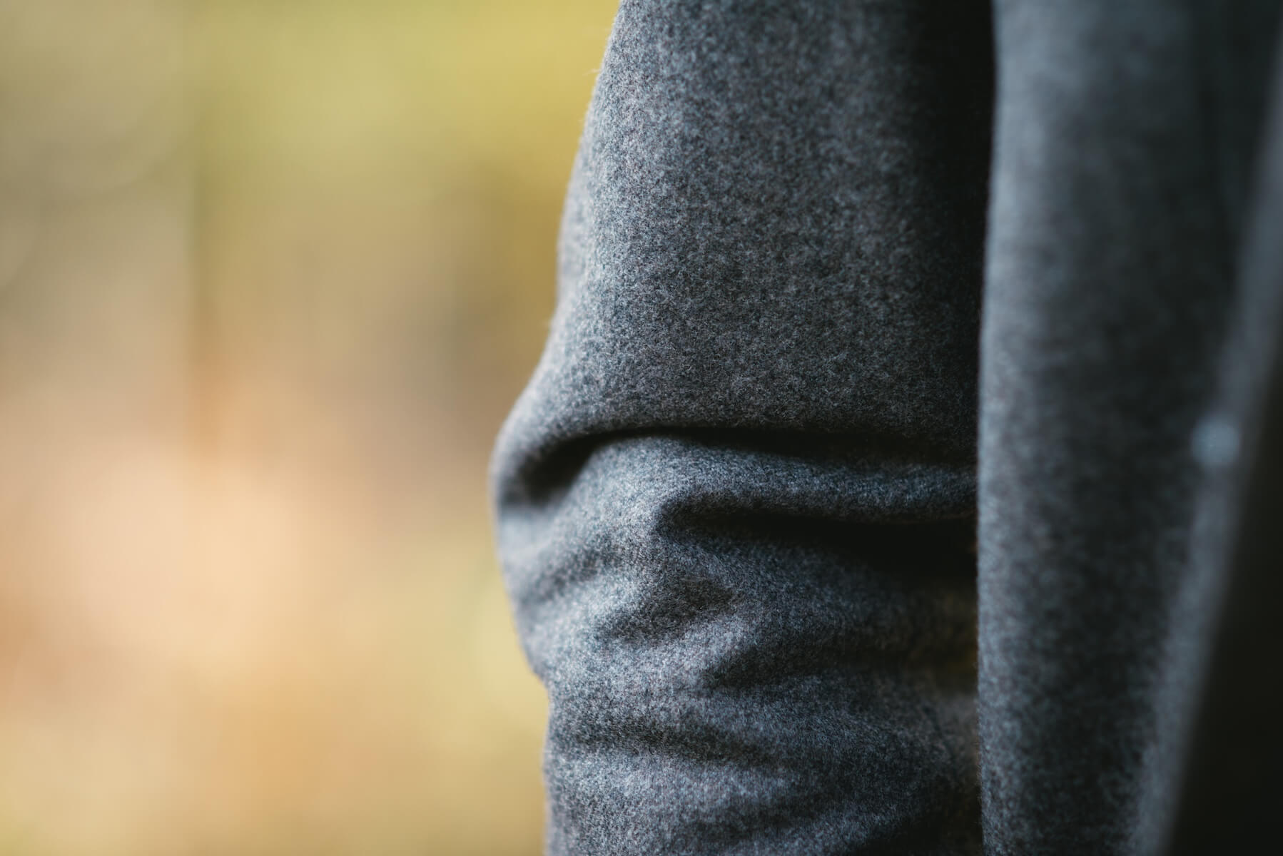 Détail d'une manche de manteau en laine grise sur mesure, Atelier Blatin